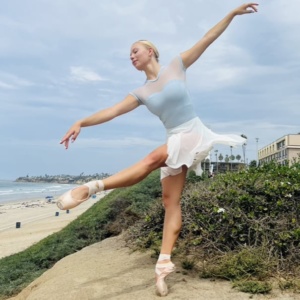 Ms. Madalynn dancing in pointe shoes near the beach.