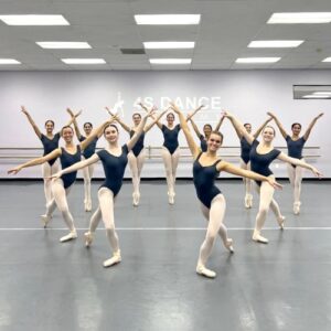 Senior ballet students posing in a heart shape.