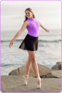 Photo of Ainsley en pointe, at the beach.